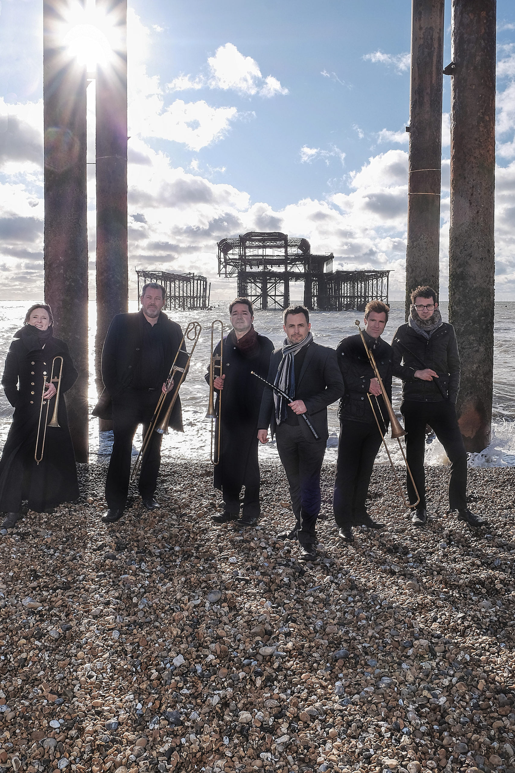 English Cornett & Sackbut Ensemble photo with a ruined pier in the background