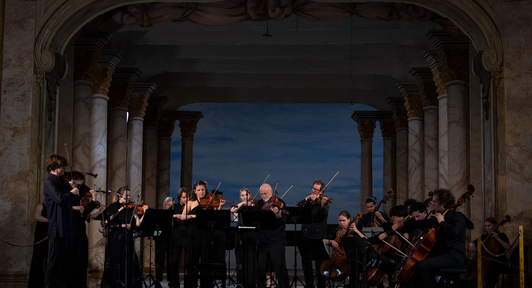 O Modernt Orchestra performing on a dark stage