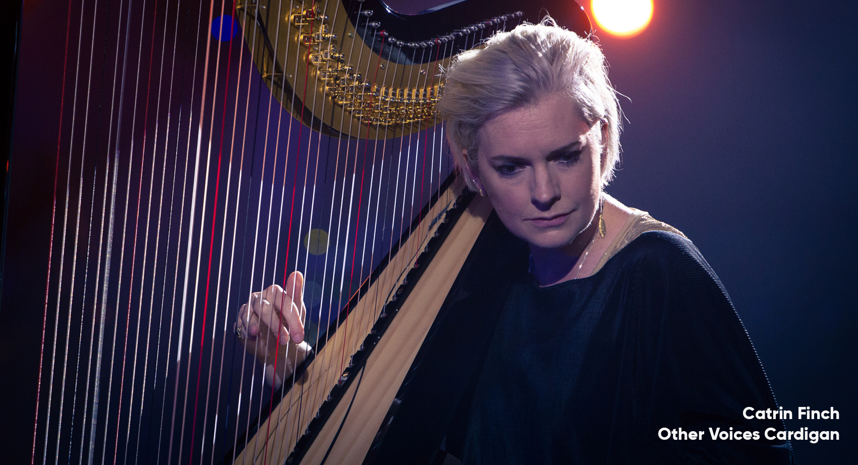 Catrin Finch playing the harp with her right hand.